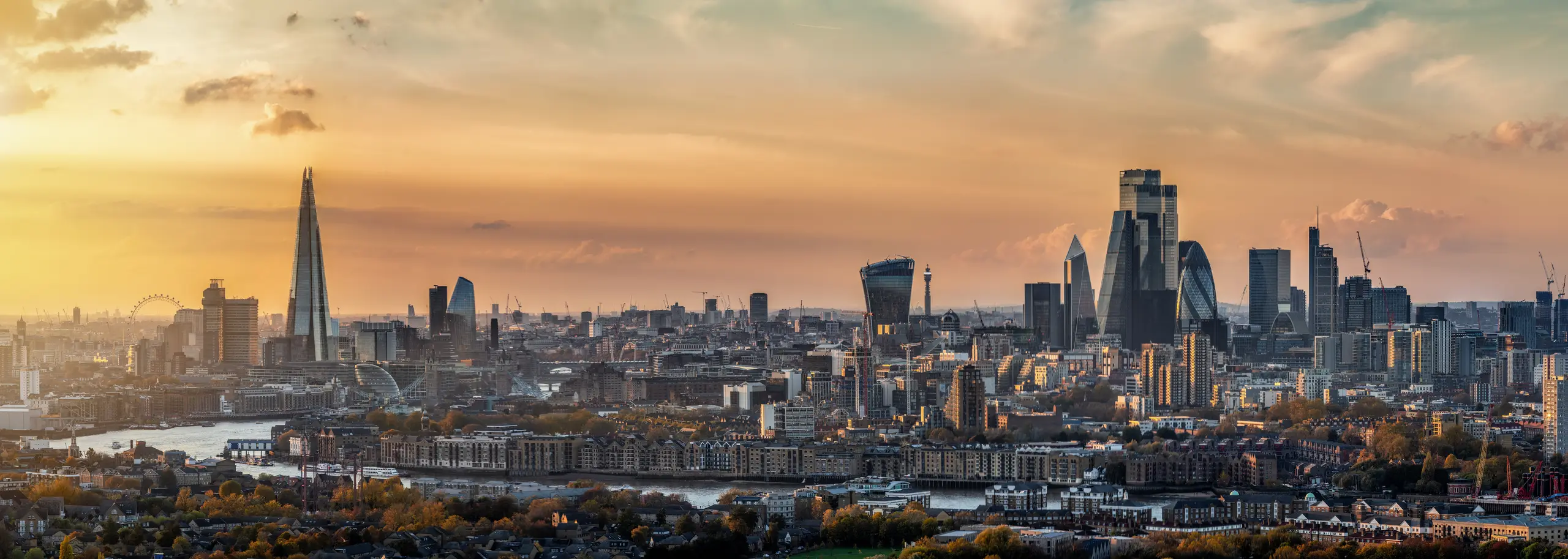 The London skyline at sunset, looking across the Thames to the Shard, the Gherkin and the towers of the City of London, where DILR.ai is based.